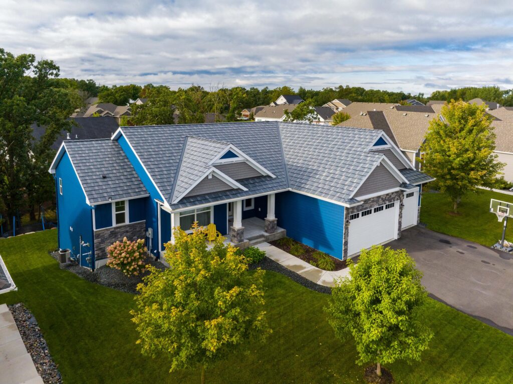 EDCO's sleek Obsidian Infiniti Roofing shingles complement the vibrant blue.